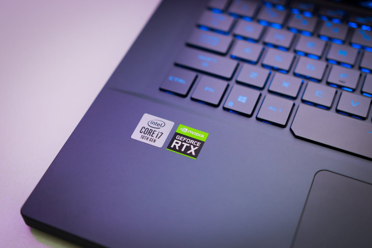 our-journey-01 Laptop keyboard with Intel Core i7 and NVIDIA GeForce RTX stickers, symbolizing high-performance computing power.